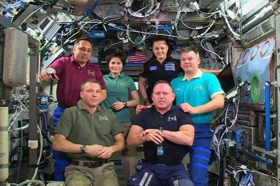 Astronauts board Soyuz to return to Earth