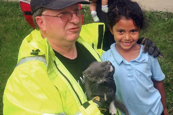 Firefighters too big, but girl just right to rescue kitten