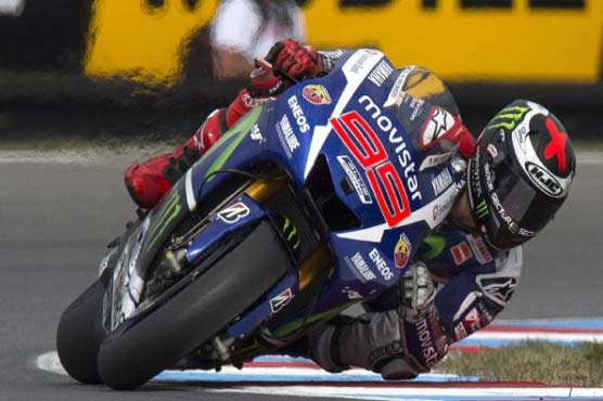 Motorcycling: Lorenzo strikes first blow against Rossi in Valencia
