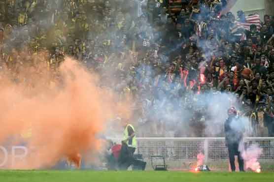 Football: Malaysia braced for punishment after flare chaos