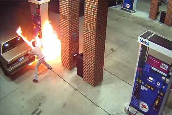 Motorist sets lighter to spider at gas station, burns pump