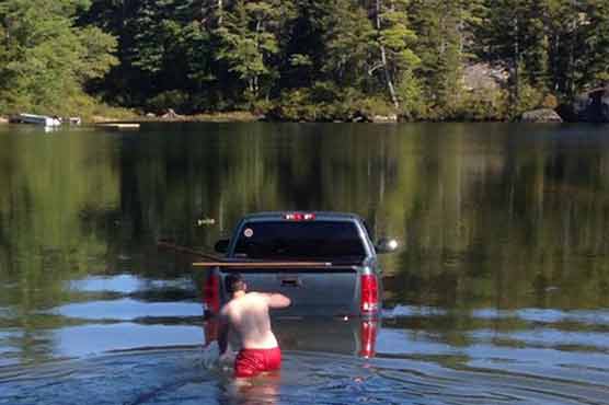 Dog rescued safely after driving idle truck into lake