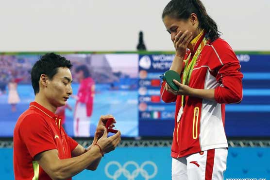Olympics: Podium proposal steals show as Shi takes gold