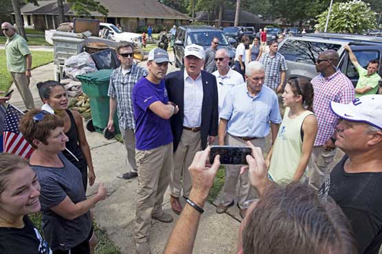 Trump visits flooded Louisiana criticises Obama