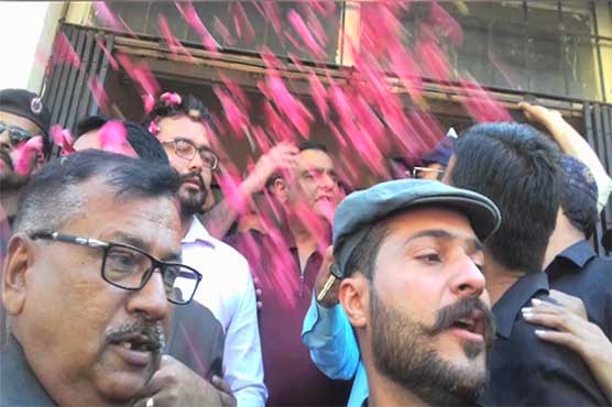 Dr Asim addresses party workers outside NAB court