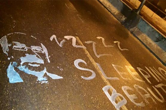 PTI worker paints Sindh CM's face on roads to highlight citizens' problems