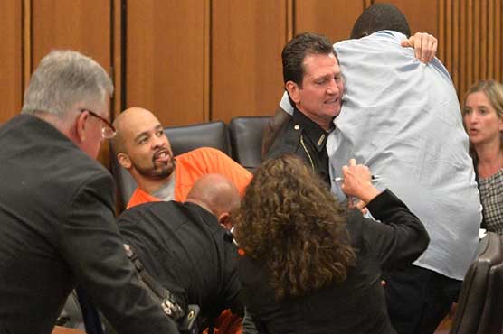 Victim's dad jumps over table to attack her killer in court