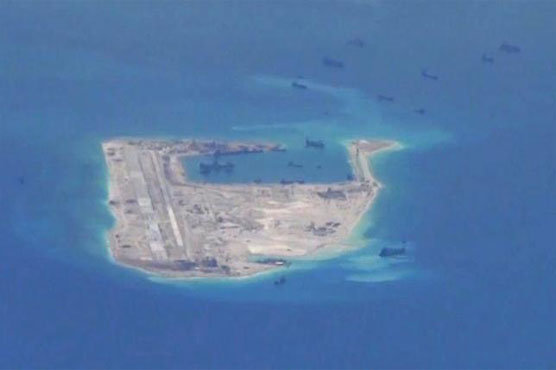 US warship sails by South China Sea reef, irking Beijing