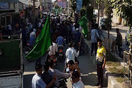 Srinagar: Kashmiris wave Pakistani flag at Mirwaiz Umar Farooq's rally