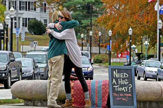 Woman upset by Trump victory spends day giving out free hugs