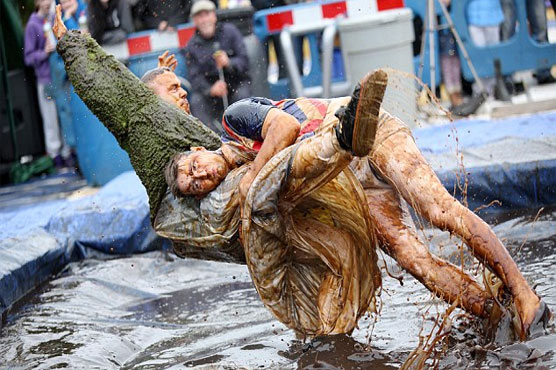 Competitors slip and slide for gravy wrestling championships