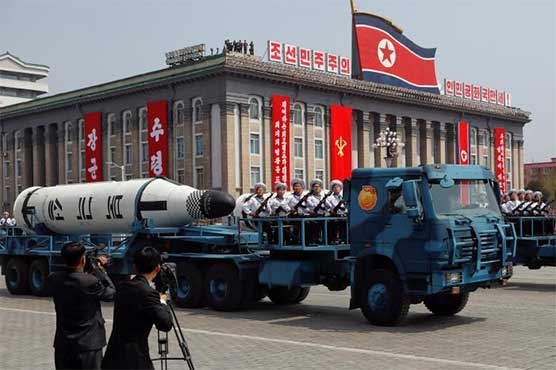 North Korea displays apparently new missiles as U.S. carrier group approaches