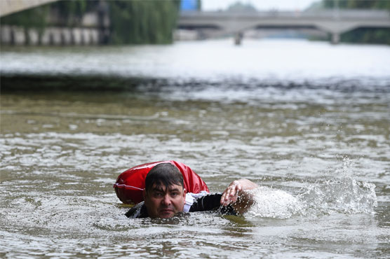 Sick of congested roads, German man swims to work