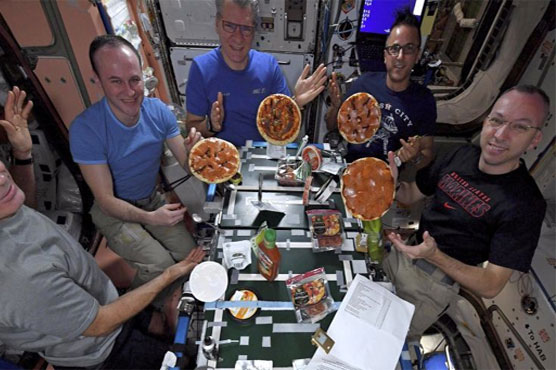 Astronauts make, fling, float, eat pizzas on space station