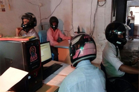 Employees wear helmet at workplace in India