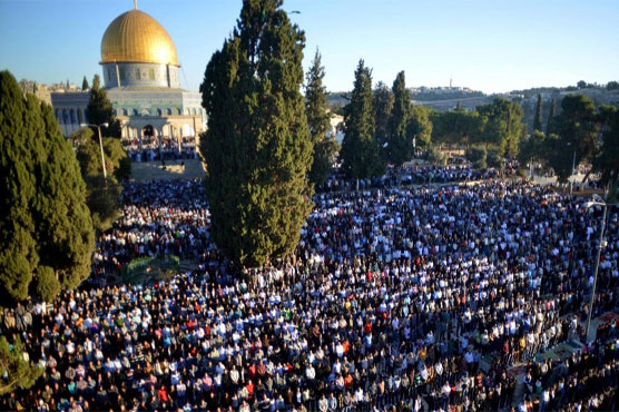 Palestinians pray outside holy site after Israeli restrictions