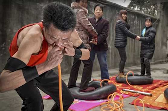 Chinese man inflates car tires with his nose