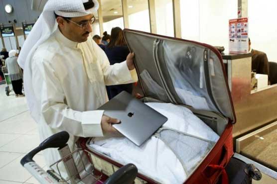Weary flyers shrug as Middle East laptop ban takes off