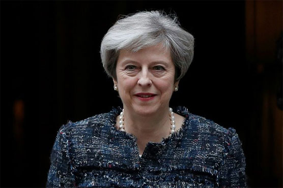 May takes tough Brexit stance as UK holds local elections