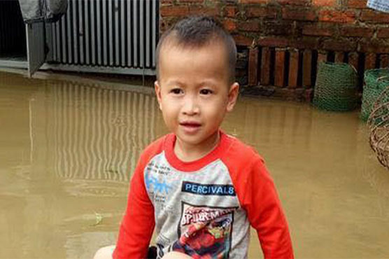 Daring three-year-old boy rides python in flood-hit Vietnam