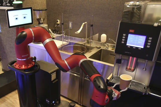 Robot amuses customers by making coffee at new cafe in Japan