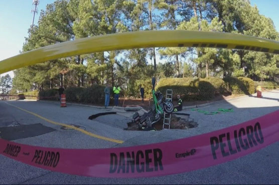 A wild ride: Sinkhole swallows man, his motorcycle