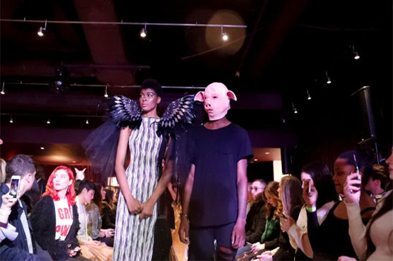 #MeToo fashion show opens with angel wing models, pig-faced men