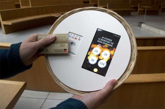No cash? Paris church basket now taking bank cards