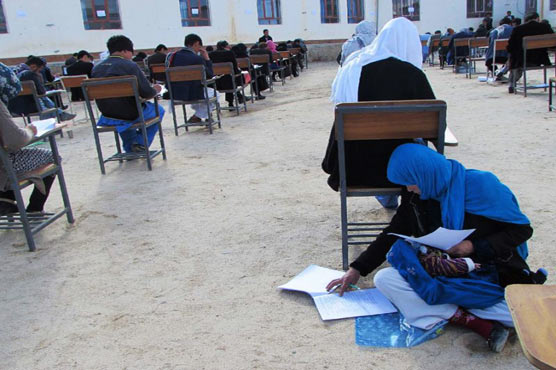Afghan mum cradling baby during university exam goes viral