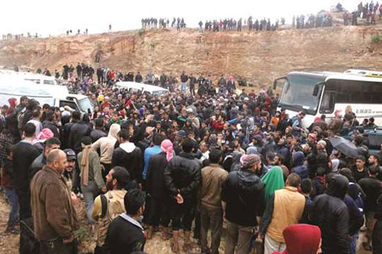 Syria rebels, civilians begin quitting central zone under new deal