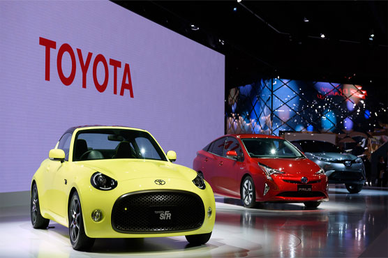 Toyota posts record full-year net profit but warns on outlook