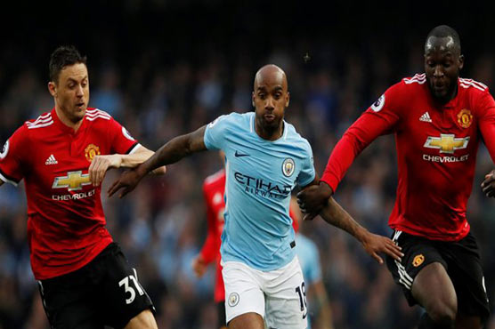 Manchester City beat Manchester United 3-1 to go top of Premier League