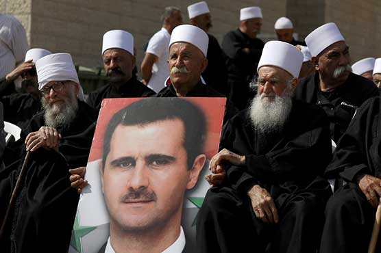 Golan Druze gather at border, chanting loyalty to Syria's Assad