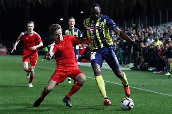 Bolt makes football debut, tires quickly