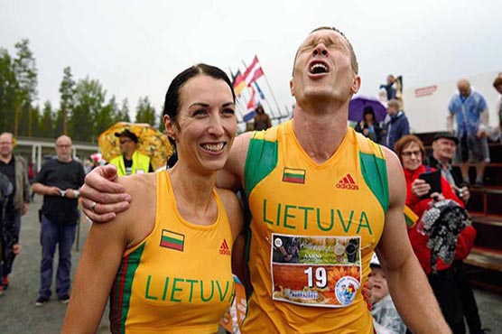 Lithuanian couple defends world wife-carrying championship title