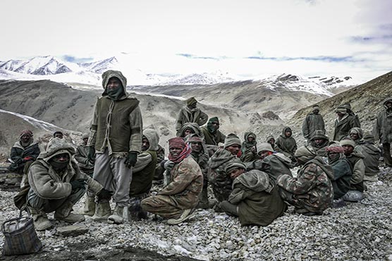 Indian workers toil at one of world's highest roads