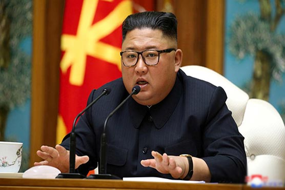 North Korea calls for tougher virus curbs, but leader wears no mask in photographs
