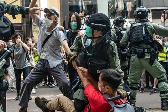Hong Kong makes first security law arrests as thousands defy protest ban