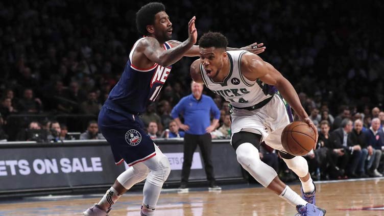 Giannis becomes Bucks' scoring leader in OT win over Nets