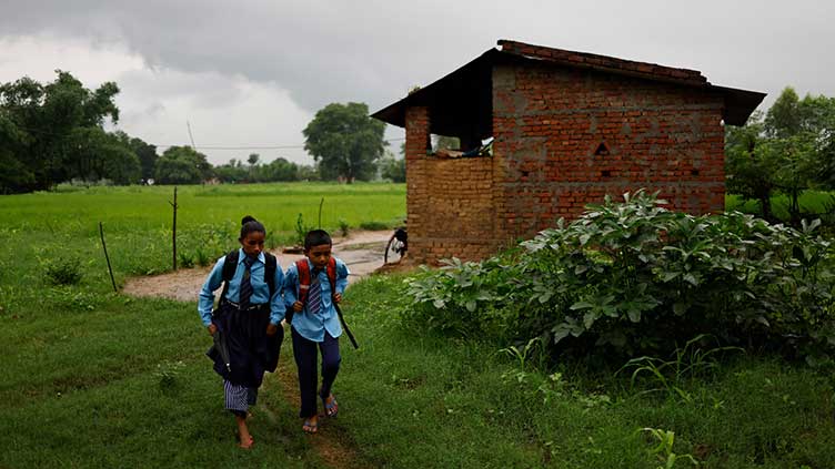 Nepali woman's quest to learn takes her back to school with son