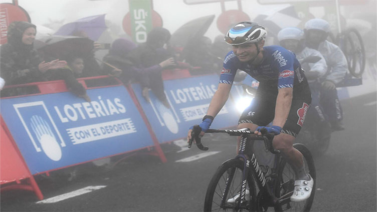 Rookie Evenepoel soars through fog into Vuelta lead