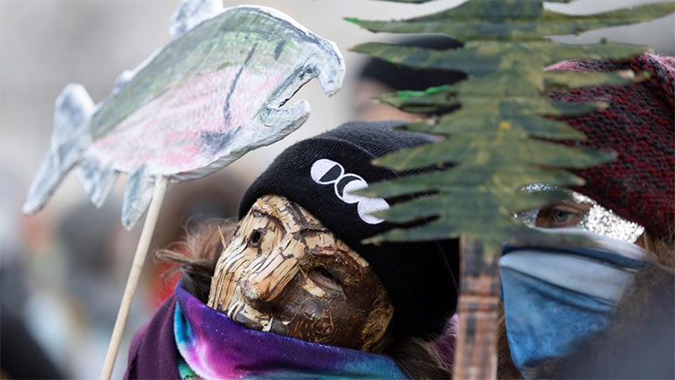 Activists dressed as birds and trees rally for nature at COP15 in Montreal