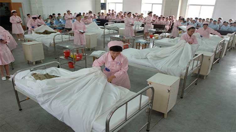 China races to bolster health system as COVID surge sparks global concern