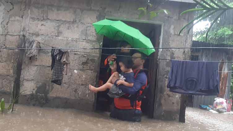 Philippines floods force tens of thousands to flee homes