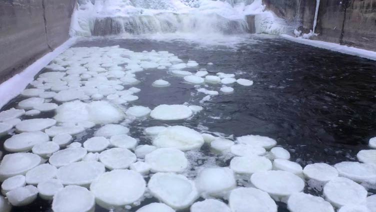 'Pancake ice' forms in water underneath Michigan waterfall