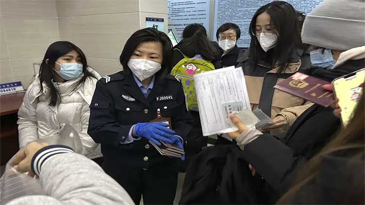 China to resume issuing passports, visas as virus curbs ease