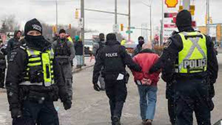 Canada police arrest 11 protesters with 'cache of firearms' at US border