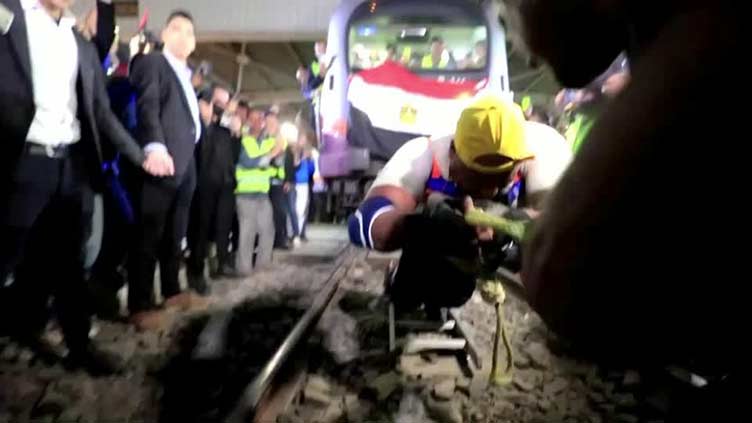Egyptian strongman pulls train along track