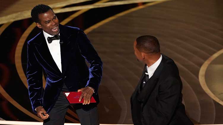 Chris Rock takes to comedy mic, still processing Oscars slap