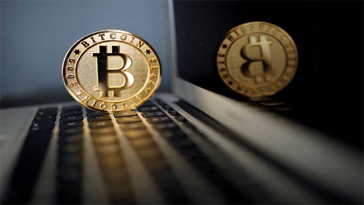 Bitcoin falls to 10-month low as stock markets tumble